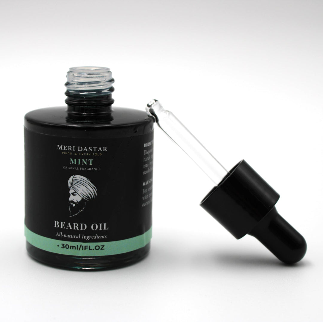 Beard oil bottle with dropper on a white background