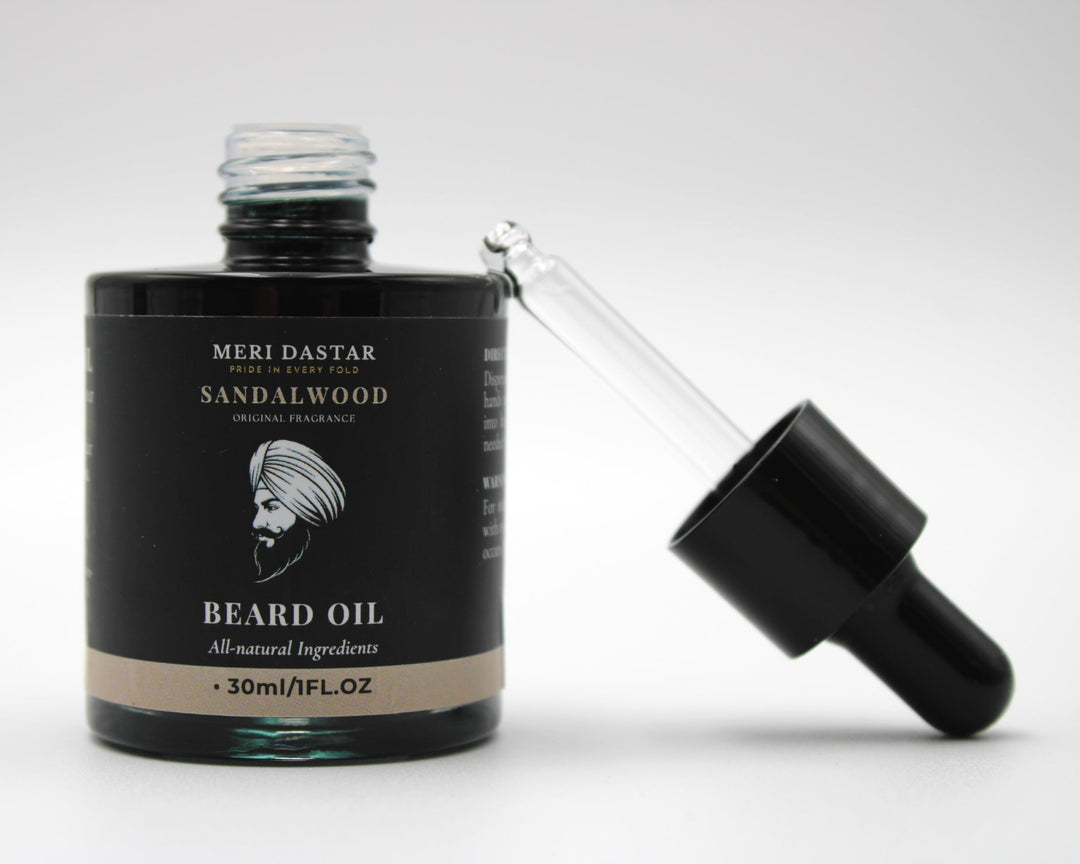Beard oil bottle with sandalwood scent on a white background