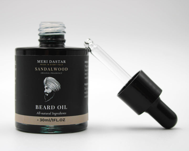 Beard oil bottle with sandalwood scent on a white background