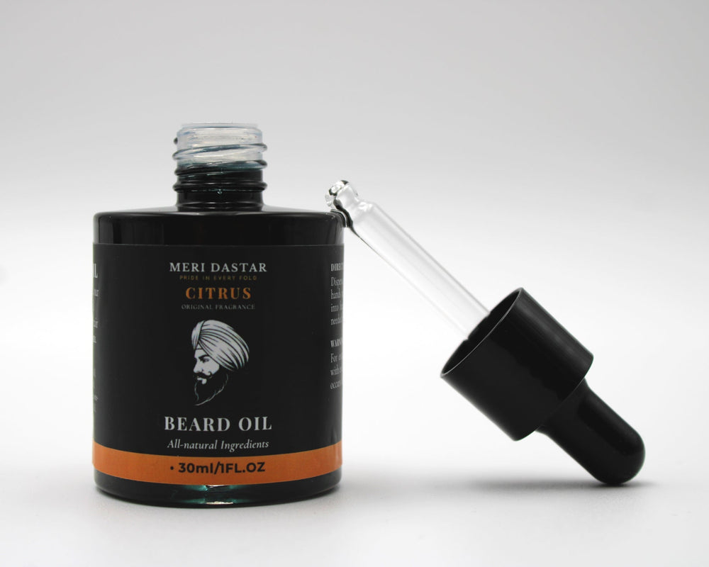 Beard oil bottle with dropper on a white background