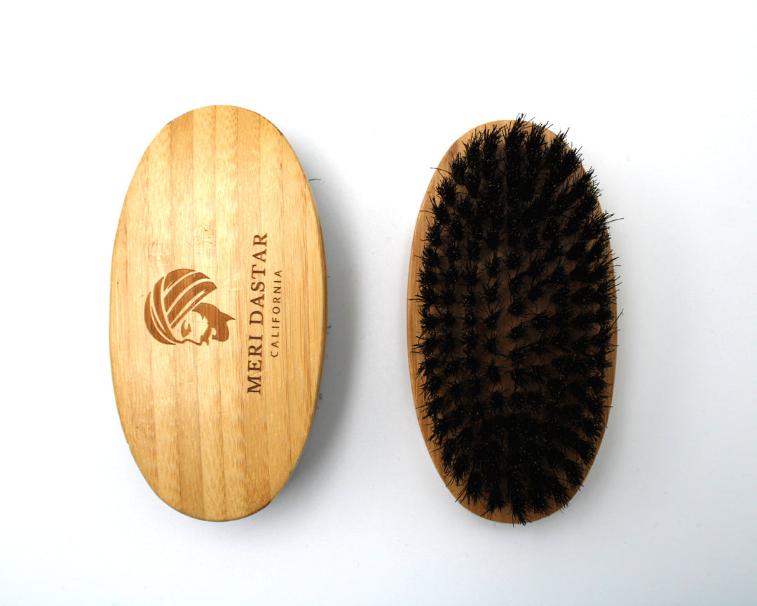 Wooden brush with bristles and Meriastar logo on a white background