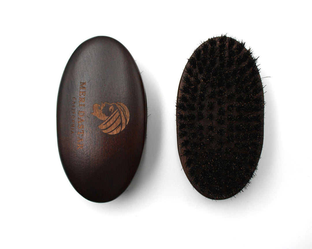 Brown leather case and black bristle brush on a white background