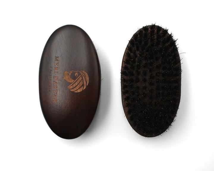 Brown leather case and black bristle brush on a white background