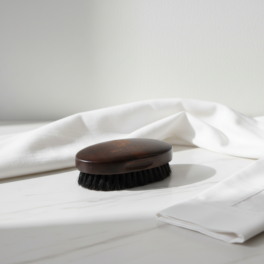 Black hairbrush with wooden handle and 'Meri Dastar' branding on a white background
